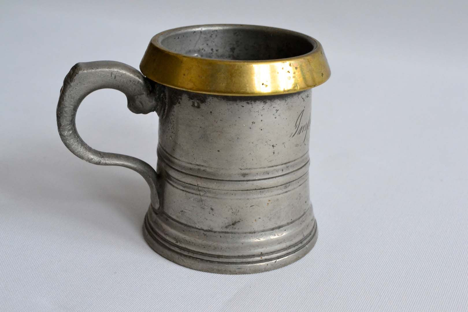 Half Pint Pewter Measure with a Brass Rim